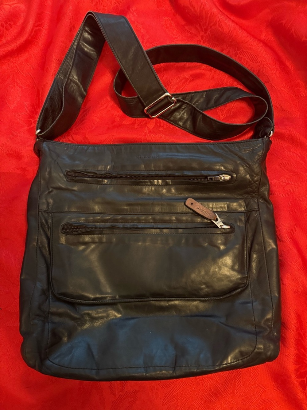 RUDSAK Black Leather Messenger Bag with Front Zip Pockets